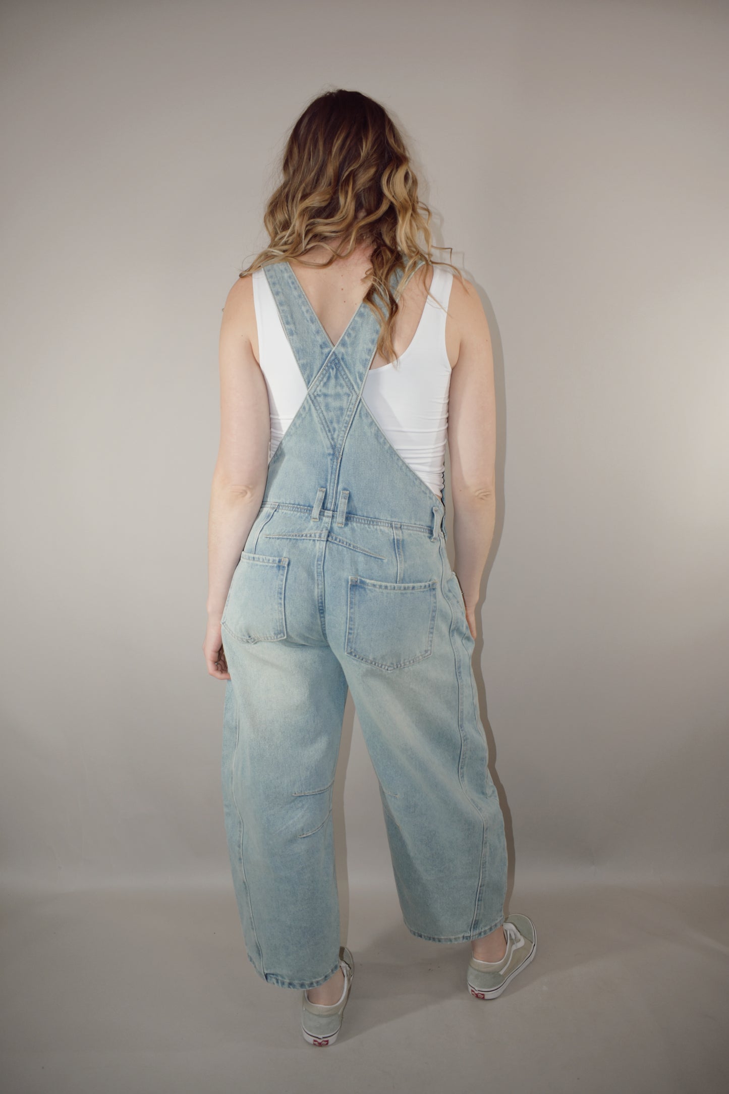 barrel jean overalls with adjustable straps, front and back pockets, beltloops, button side enclosure, front patch pockets, light wash, no holes, seam detailing around knees and back waist