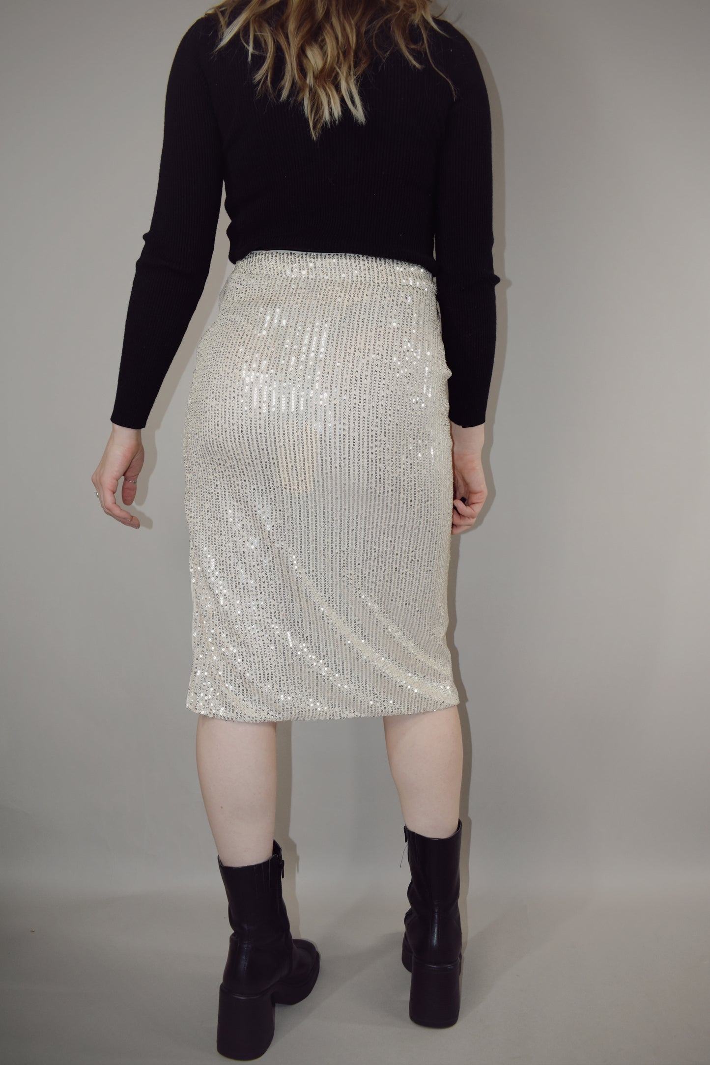 ivory sequin midi pencil skirt with side slit and side zip enclosure hits just below the knee