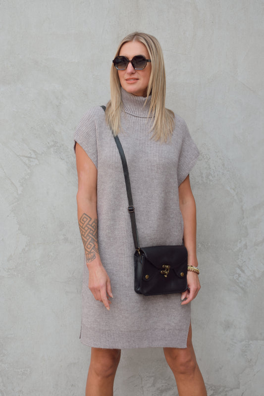 turtleneck sleeveless mini sweater dress hits rig above the knee has slits on side of hem relaxed cap sleeve, straight fit