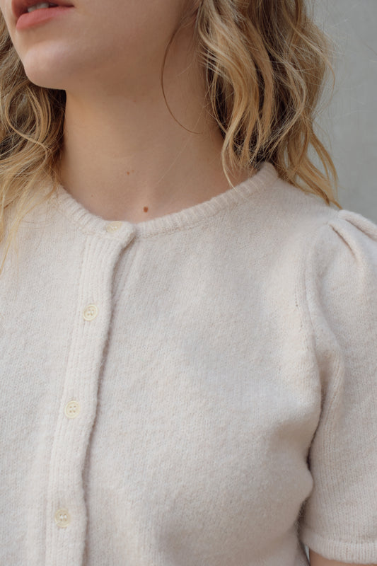 short sleeve cardigan sweater with crew neckline and slight puff sleeves gathered at shoulder, ribbed hem, straight fit, hits at waistline