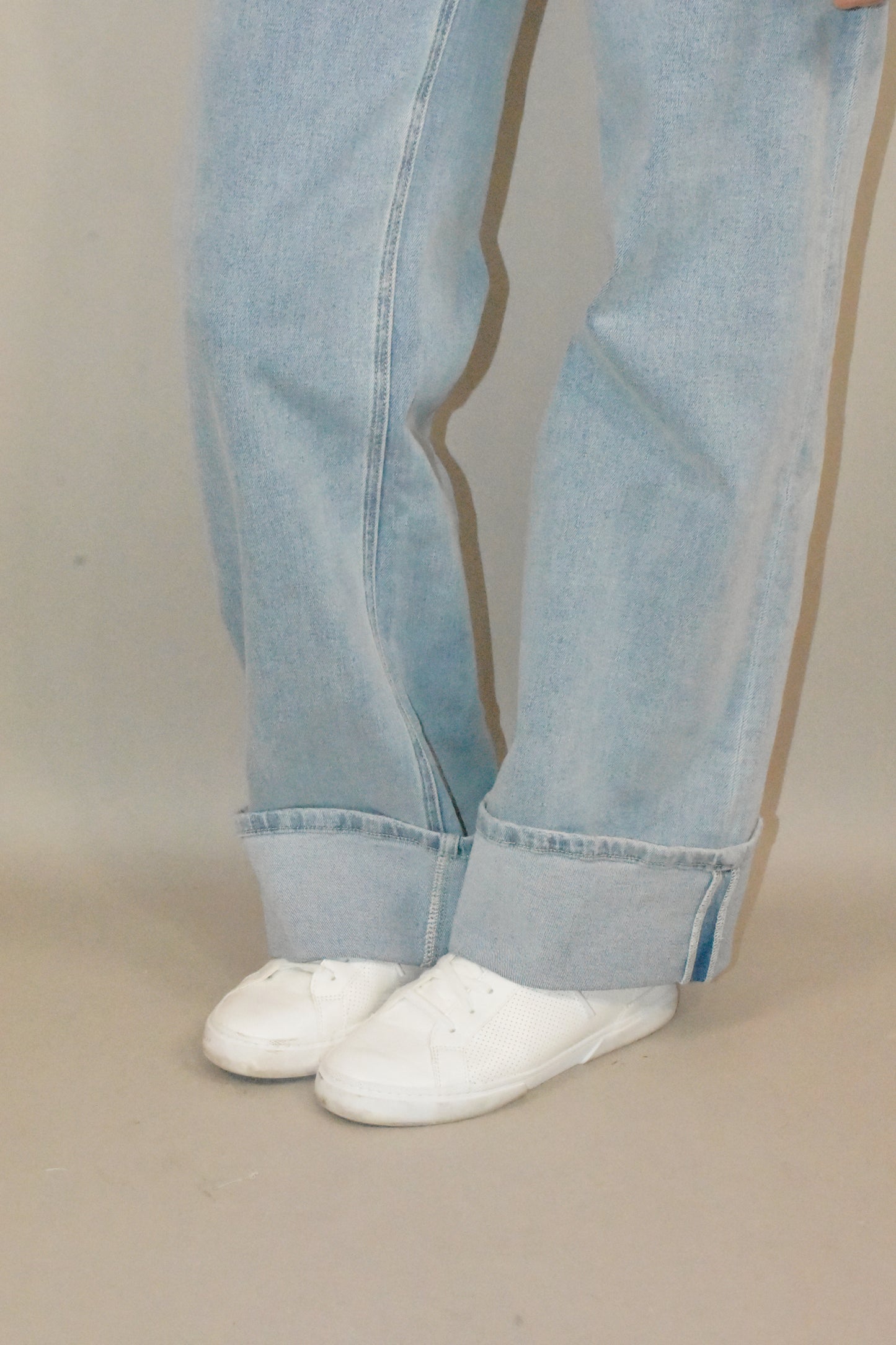 wide leg cuffed light wash stretch denim jeans with deep front patch style pockets and has a side carpenter pocket, no holes, zip and button enclosure, high rise.