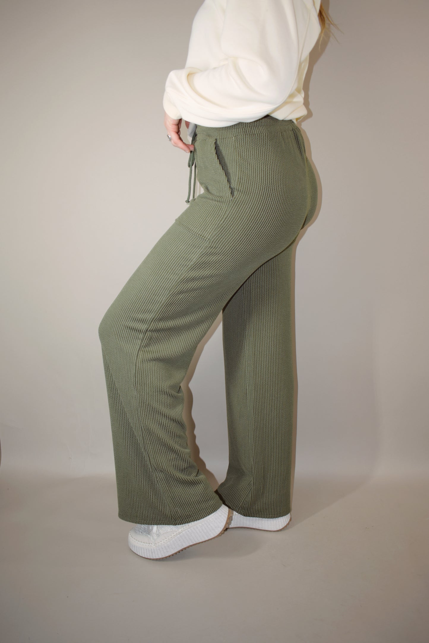 full length high waisted wide leg ribbed olive green athleisure pants with elastic waistband, drawstring, and front pockets.