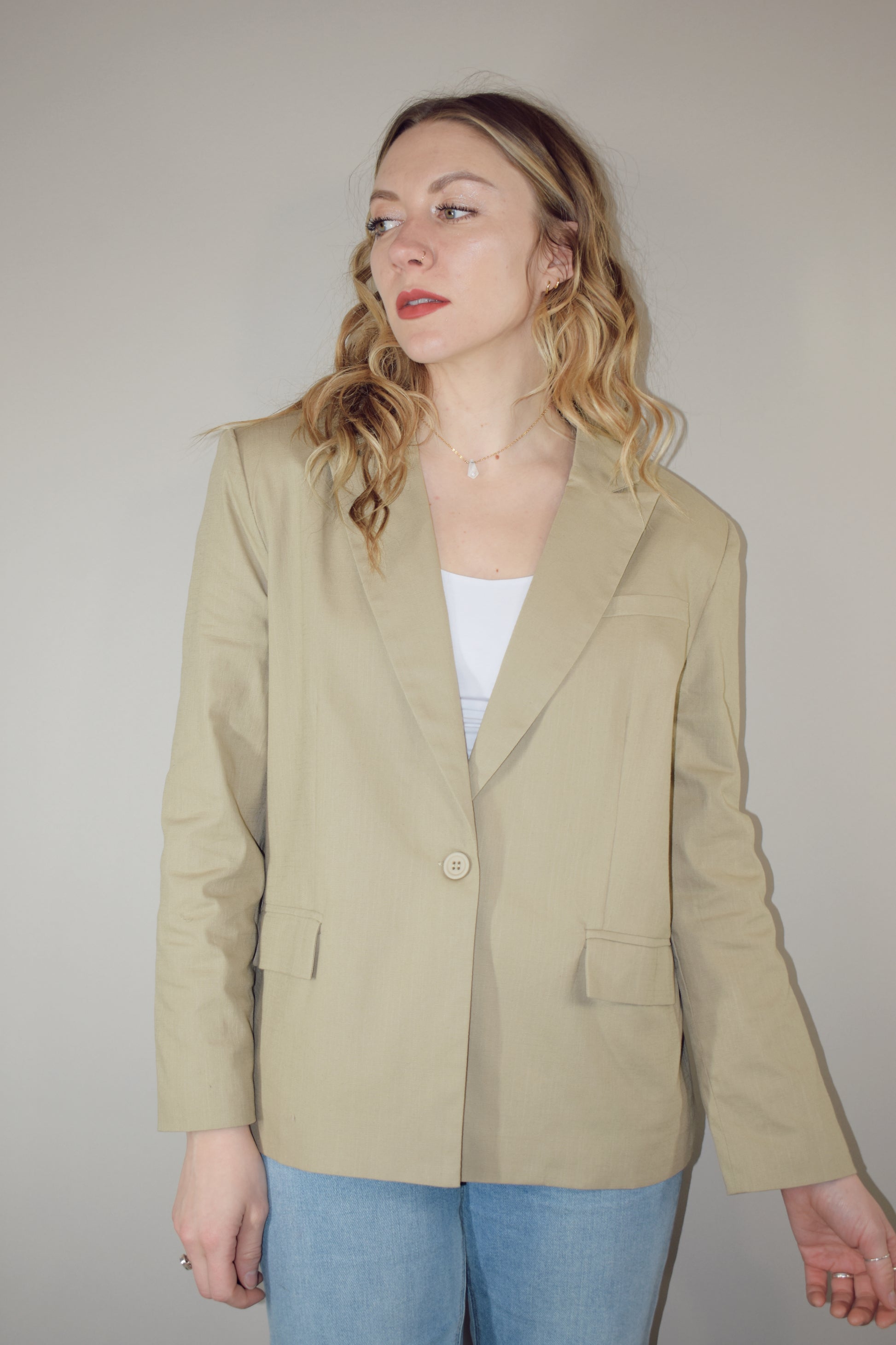 nude linen blazer full length front pockets with flap enclosure single button enclosure slit in back hemline relaxed shoulder pad structure