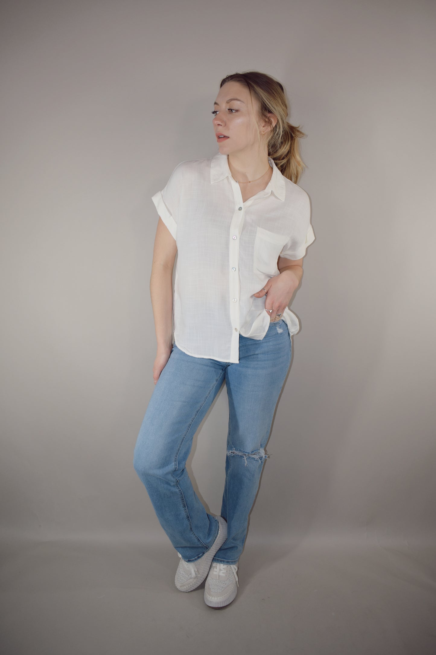 rayon white short sleeve collared button down with cuffed sleeves, one breast patch pocket, loose fit, full length, lightweight.