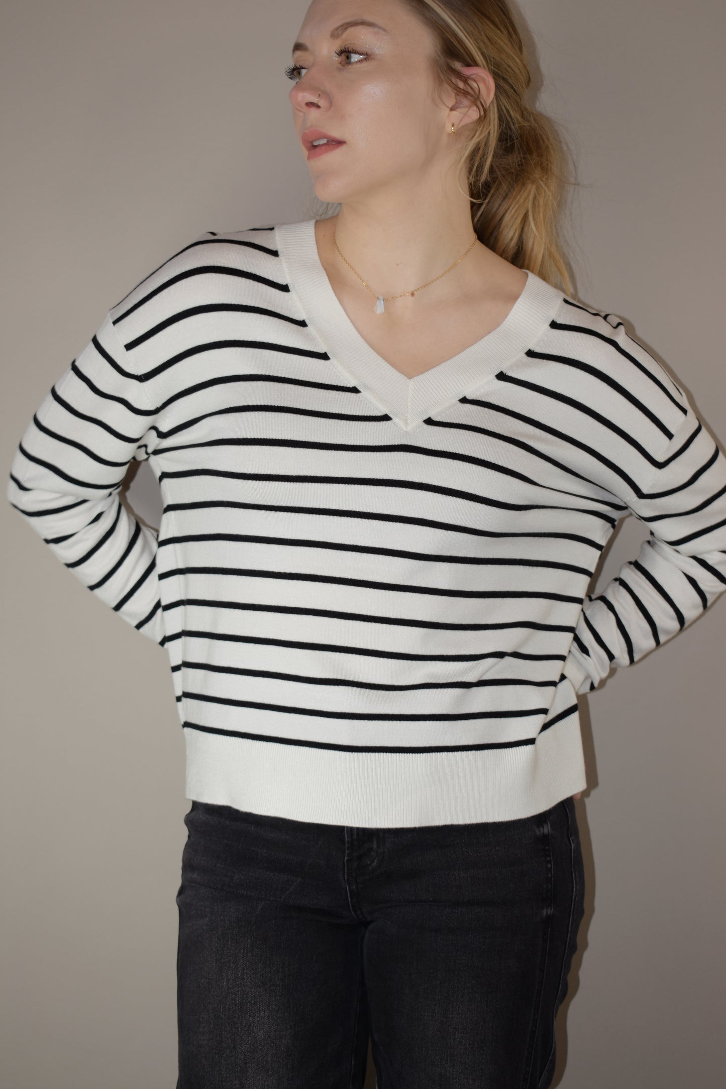 long sleeve full length v neck light weight sweater with horizontal black stripes, solid white hem, loose fit, drop shoulders, super soft.