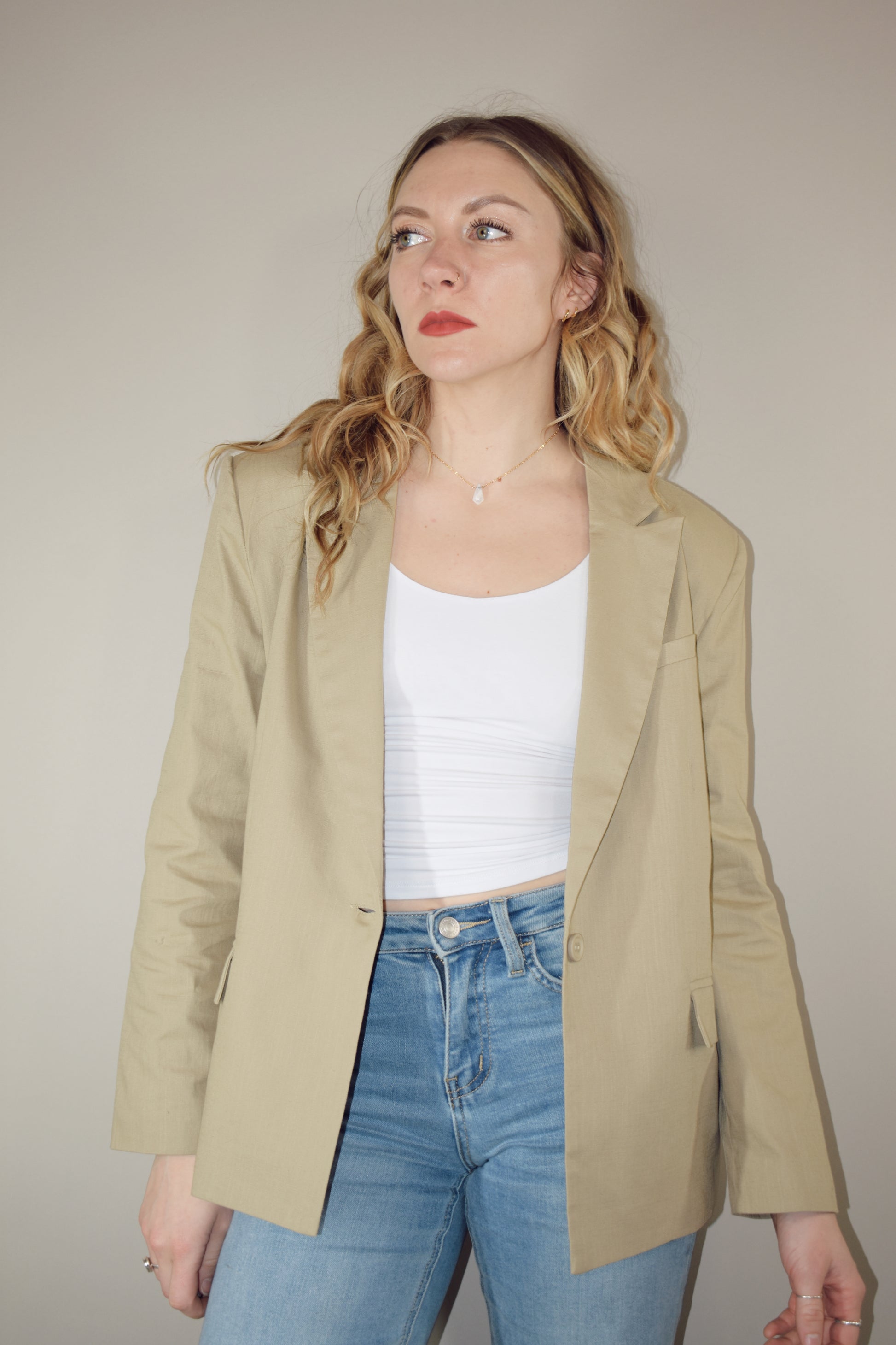 nude linen blazer full length front pockets with flap enclosure single button enclosure slit in back hemline relaxed shoulder pad structure