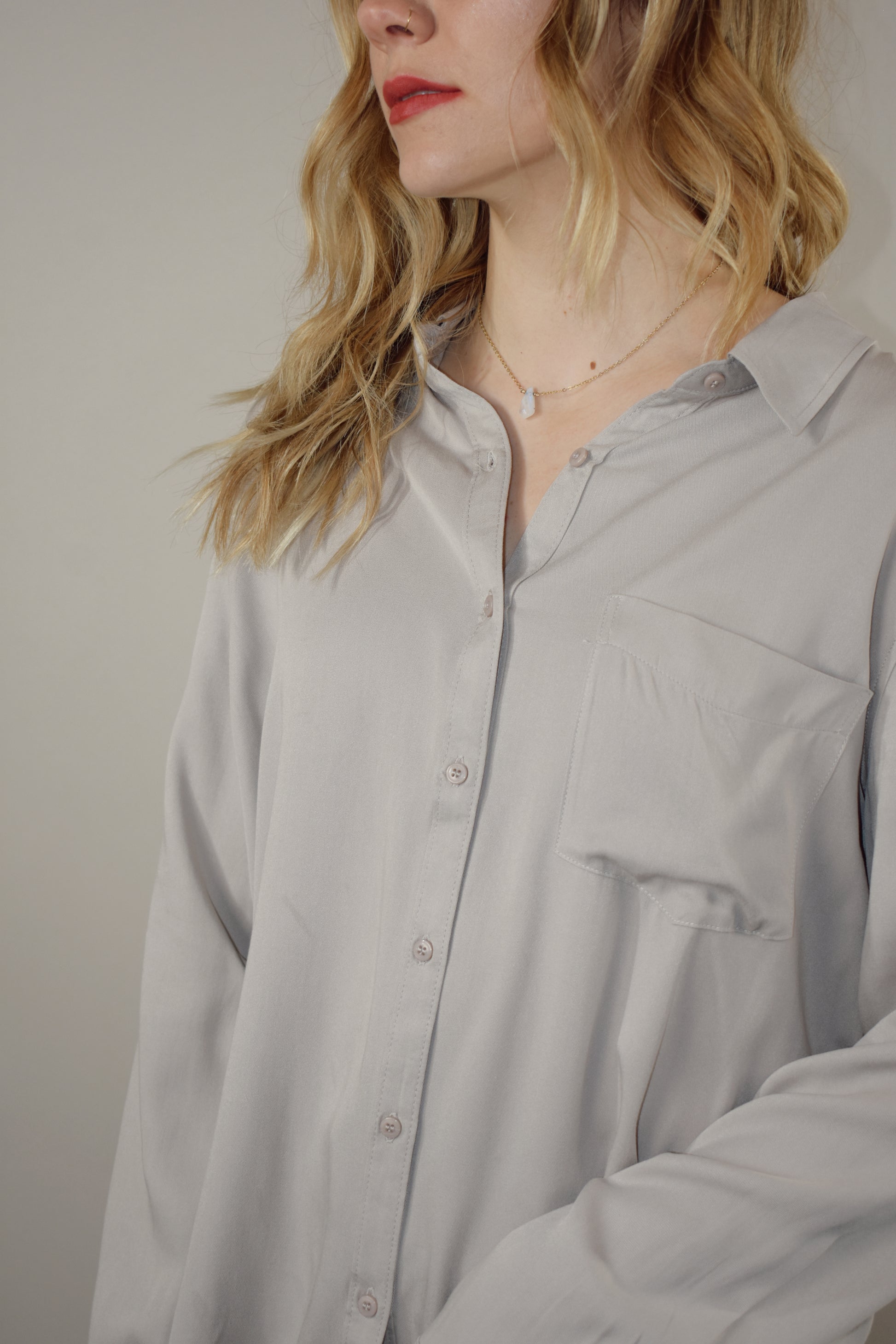 long sleeve full length button down with one patch breast pocket slits along sides on hem 