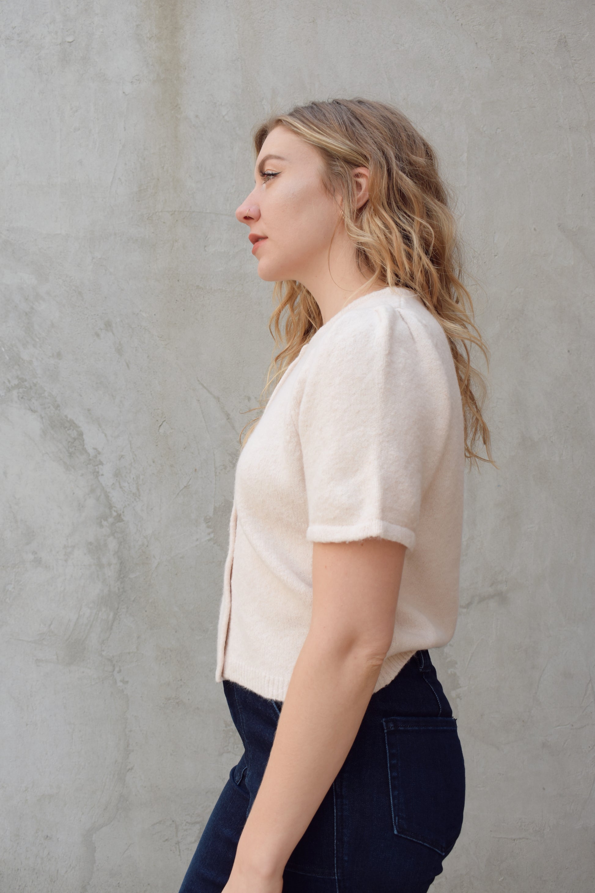 short sleeve cardigan sweater with crew neckline and slight puff sleeves gathered at shoulder, ribbed hem, straight fit, hits at waistline