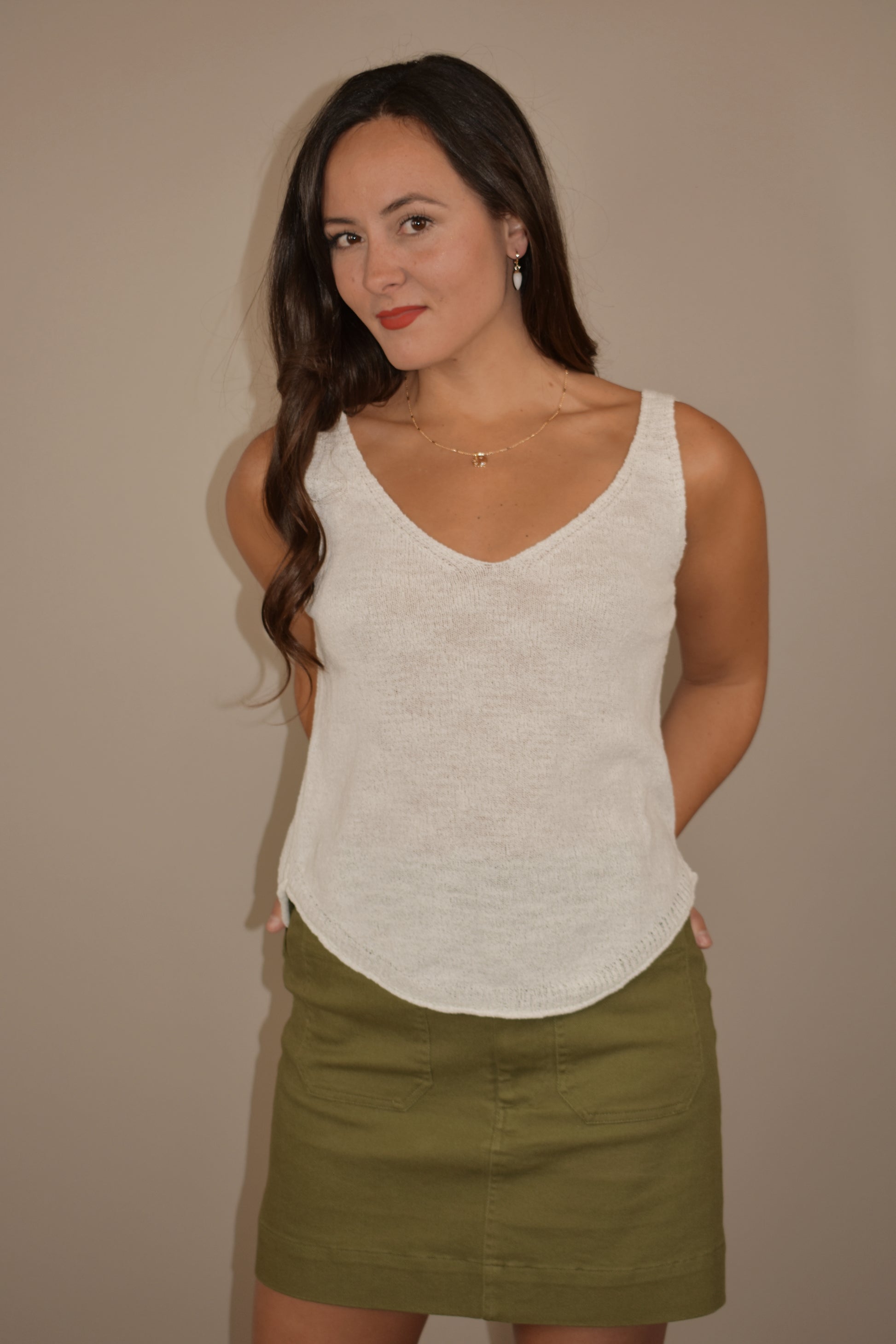 thin and lightweight sweater tank with v neck and rounded hem. full length. relaxed fit.