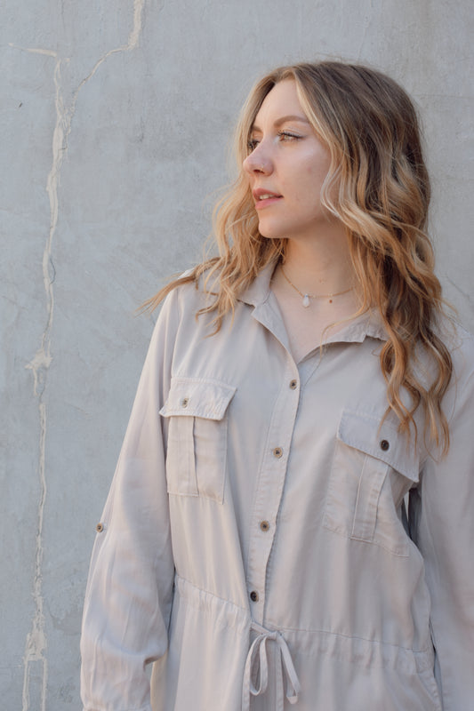 tencel utility long sleeve mini dress with cuff and button sleeves, button down front enclosure, drawstring at waist, breast utility patch pockets with flap and button enclosure, has side pockets, scoop and side slit hem, loose fit