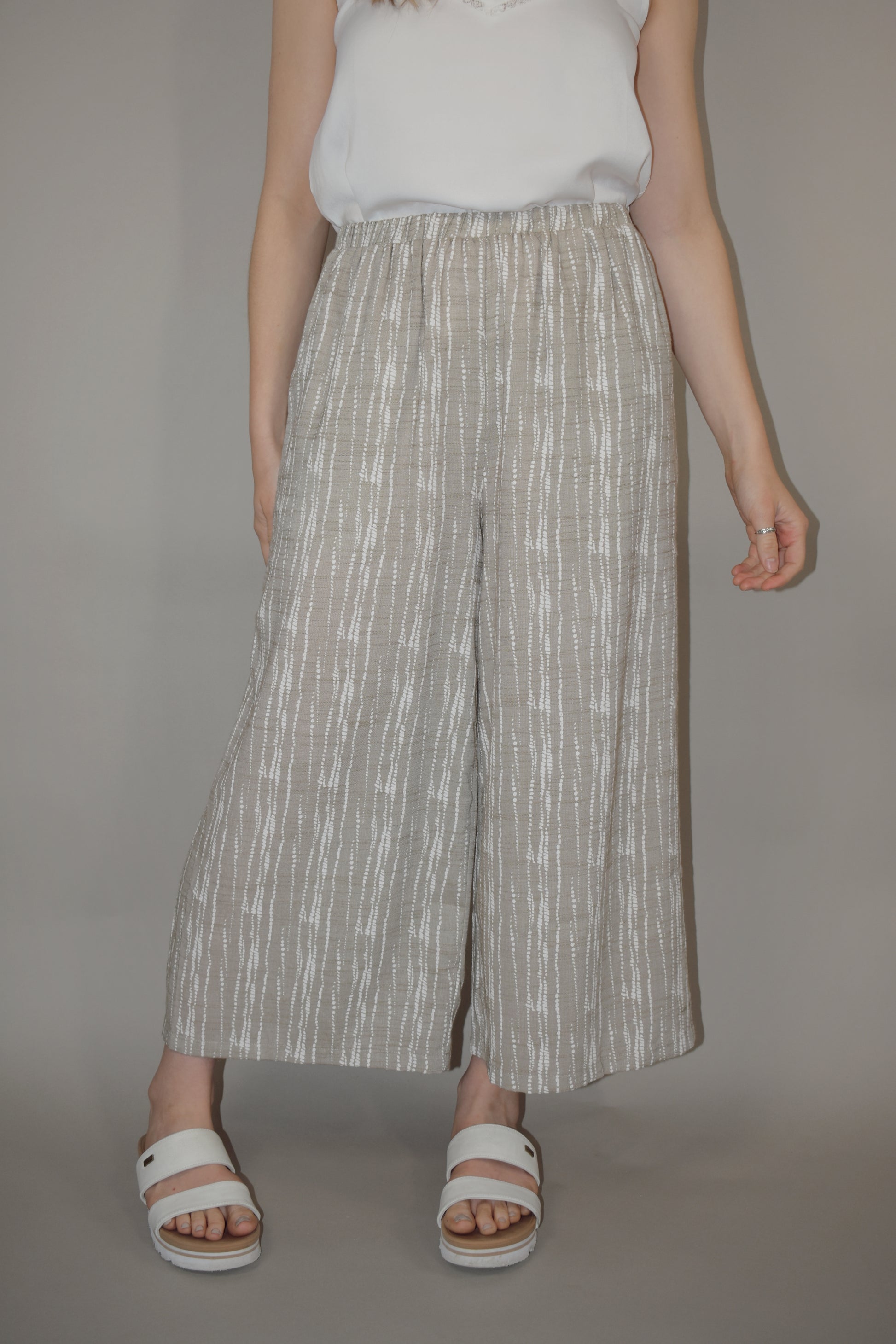 flowy cream and white printed pants slightly cropped, elastic waistband, has pockets, lightweight