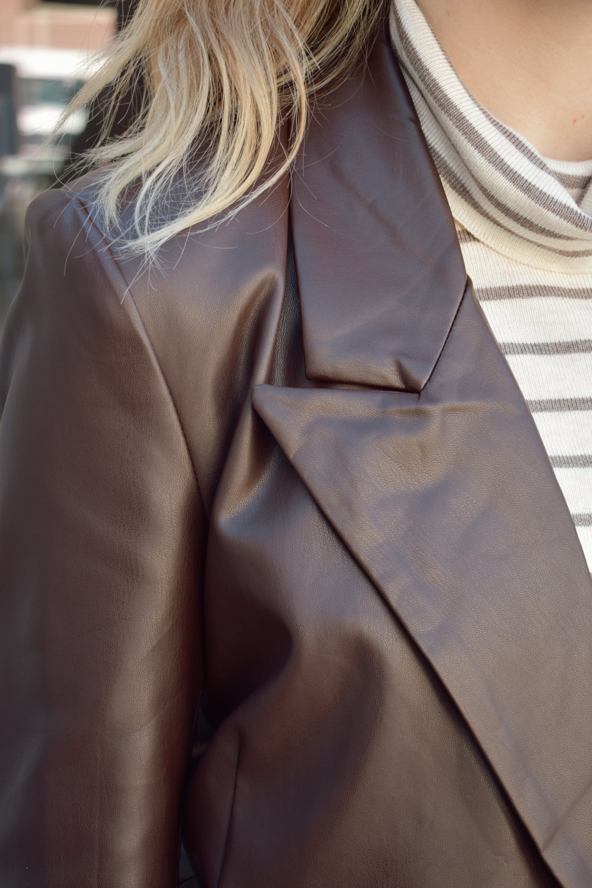 brown faux leather blazer with front flap pockets and front lapel hits at upper thigh split in back hem - fitted