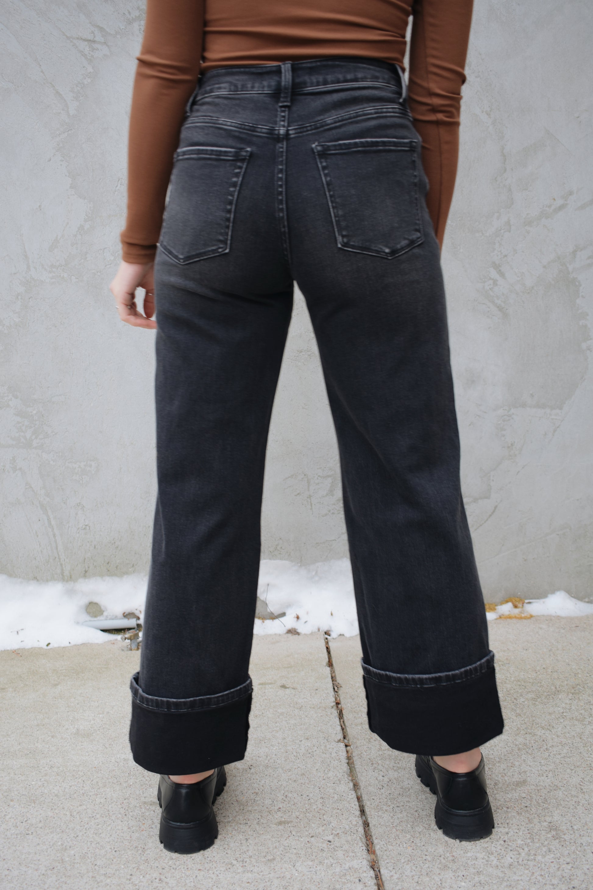 high rise stretch denim black wash no holes wide leg double panel with double front pocket has beltloops zip and button enclosure wide cuff at hem that can be uncuffed