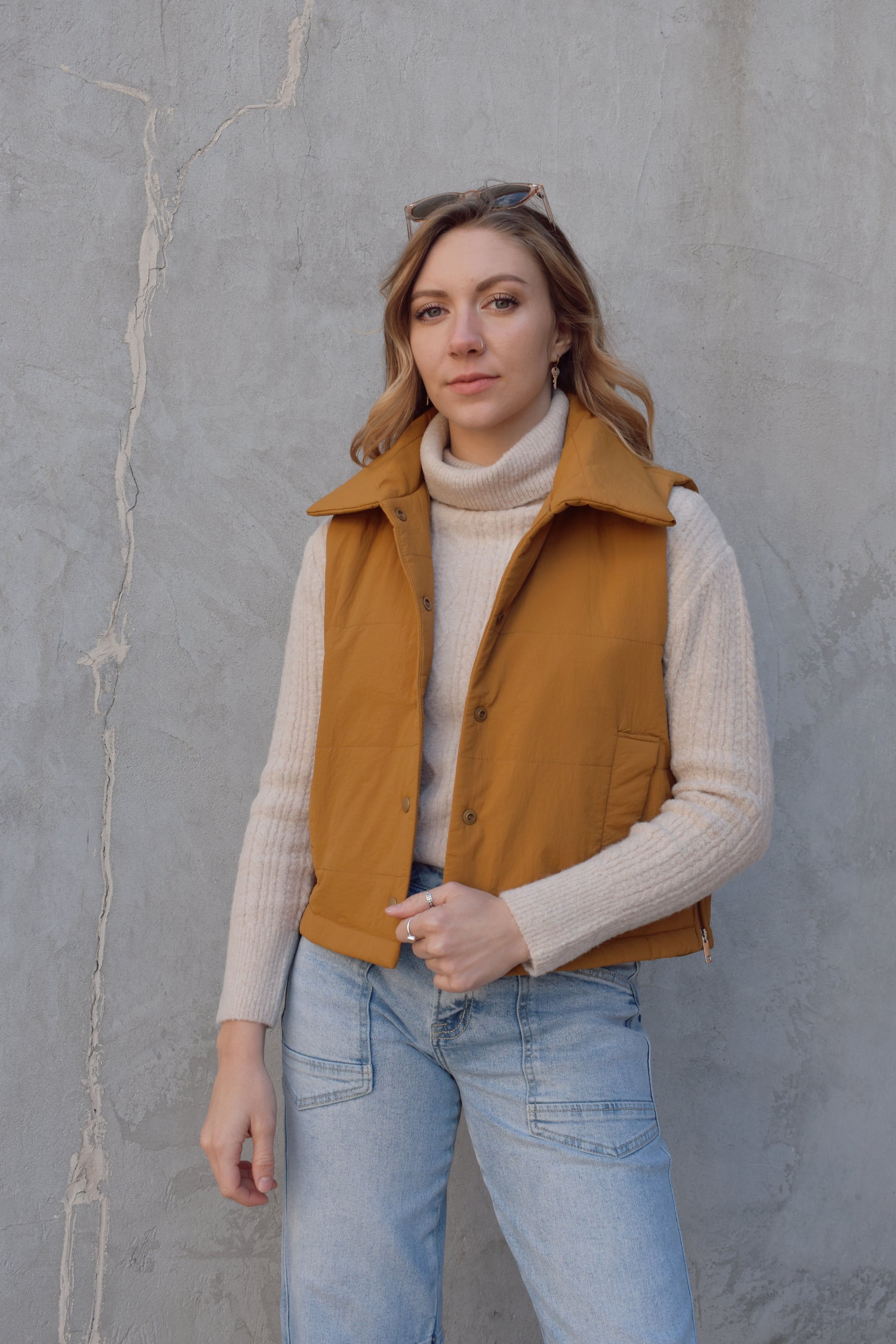 quilted vest with snap enclosure, fold over collar, pockets, side zippers, slightly cropped