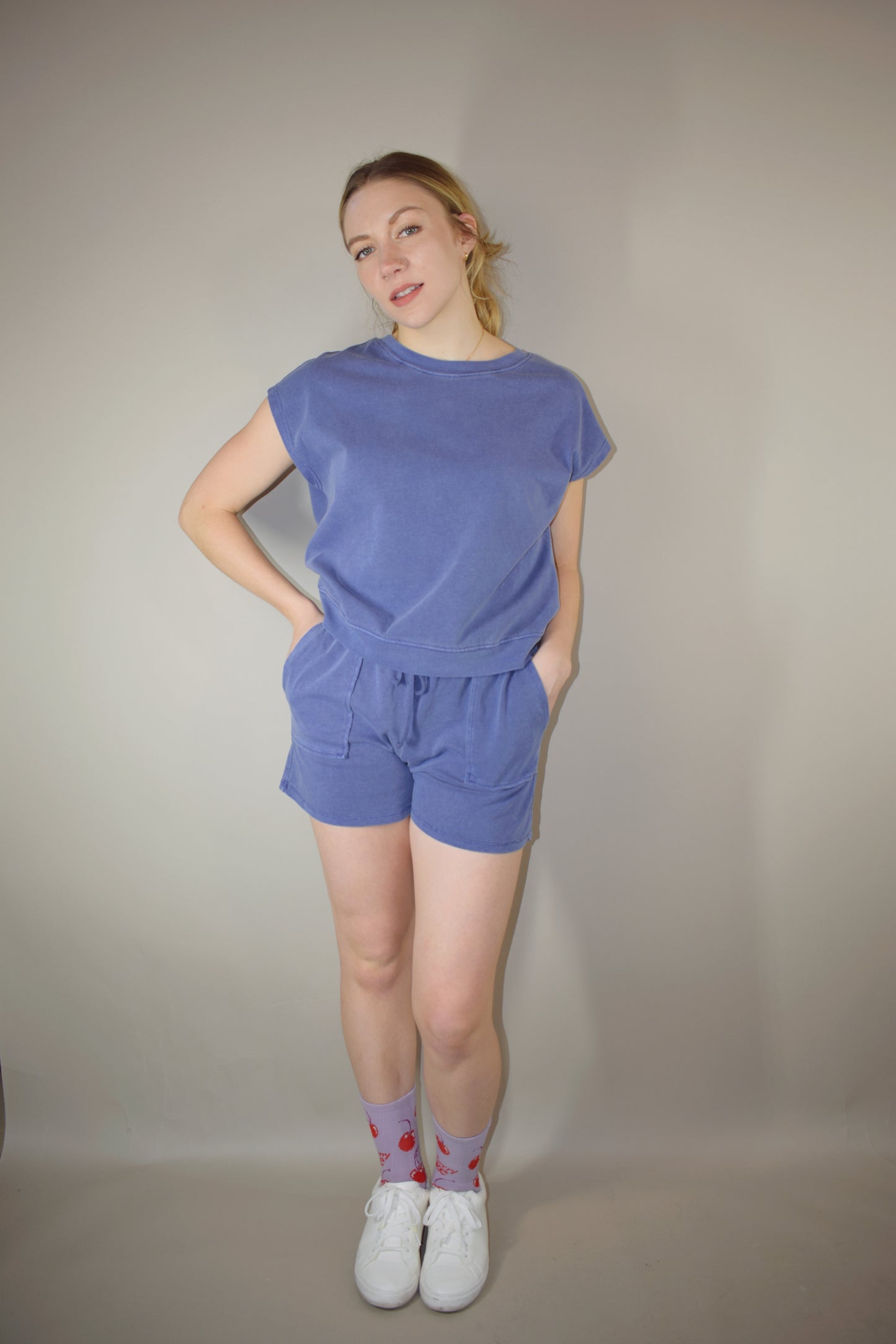 athleisure set with cap sleeve/ tank style top relaxed fit with crew neckline and athletic shorts that hit upper thigh with front pockets and a elastic waistband with drawstring