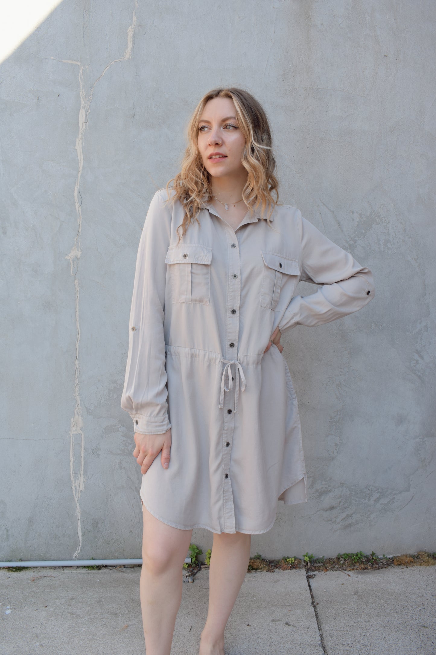 tencel utility long sleeve mini dress with cuff and button sleeves, button down front enclosure, drawstring at waist, breast utility patch pockets with flap and button enclosure, has side pockets, scoop and side slit hem, loose fit