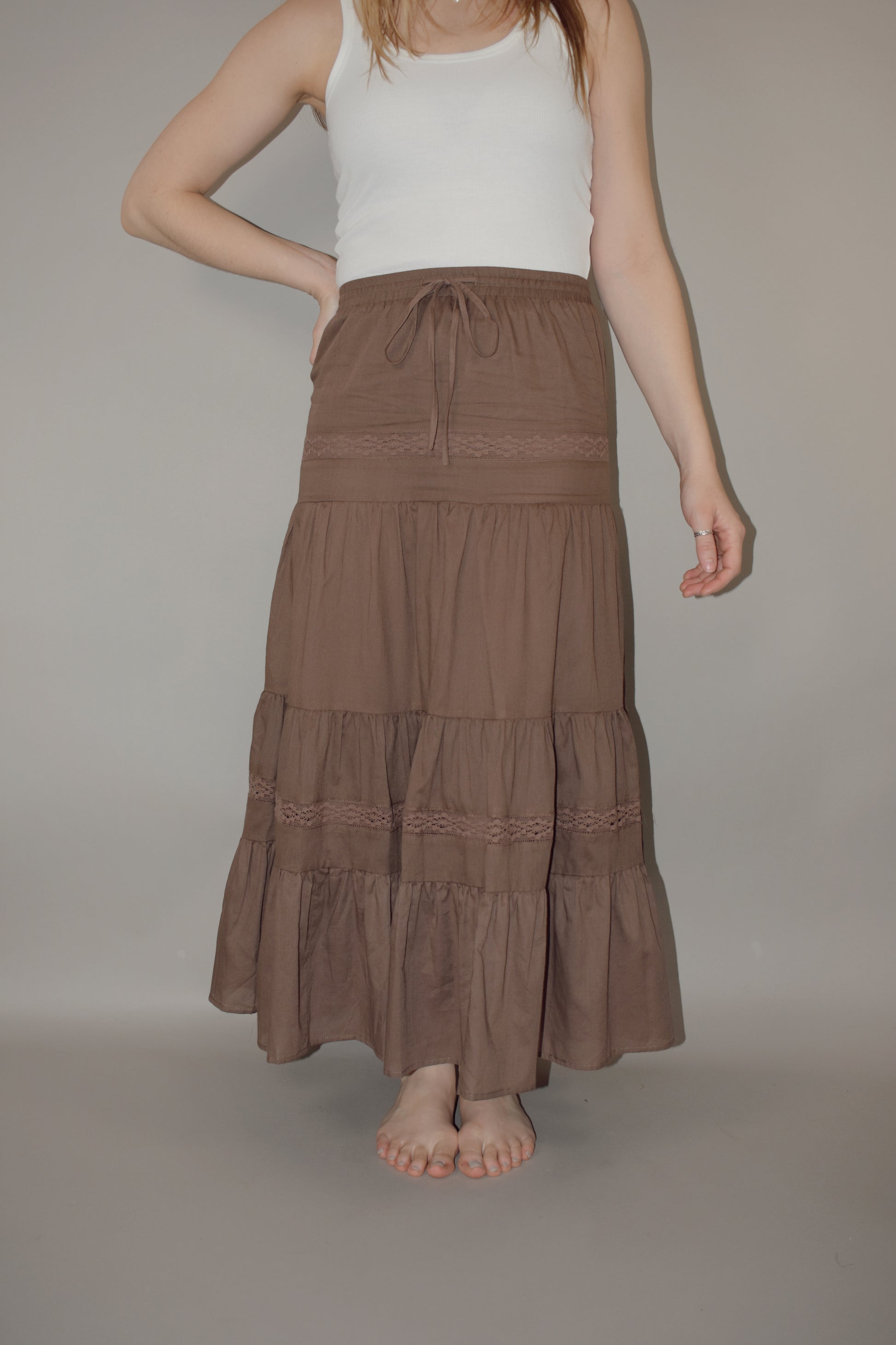 tiered maxi skirt with lace detailing and a elastic waistband with drawstring, has a liner 