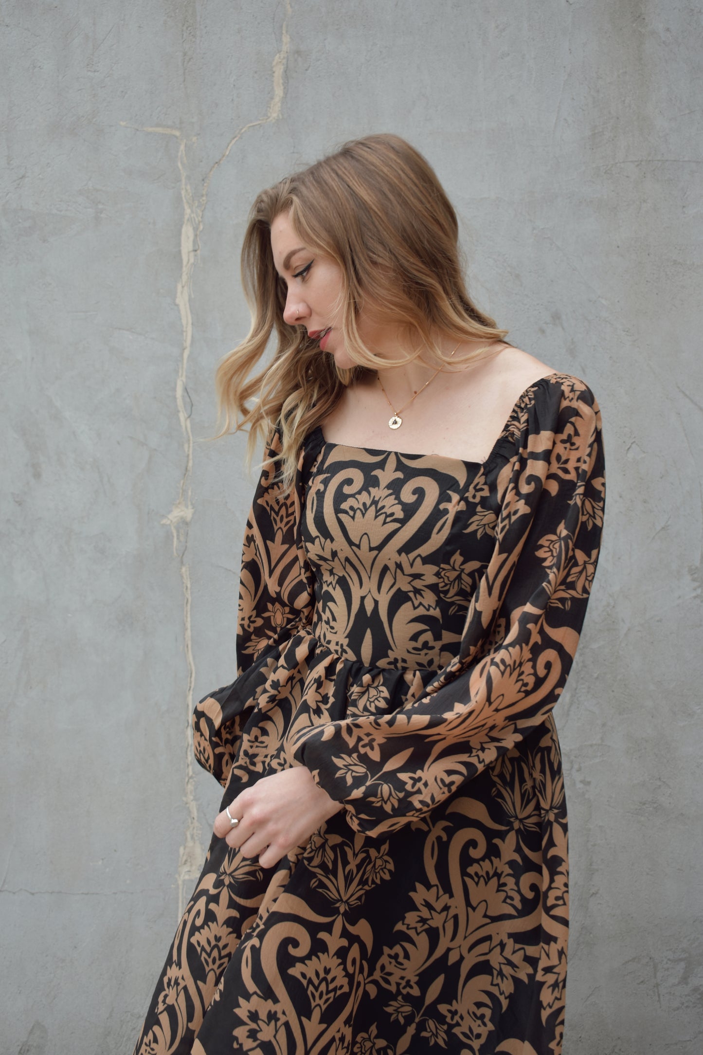 black and dark taupe dark bohemian print midi dress with square neckline front and back, balloon sleeves, flowy skirt, and zip back enclosure