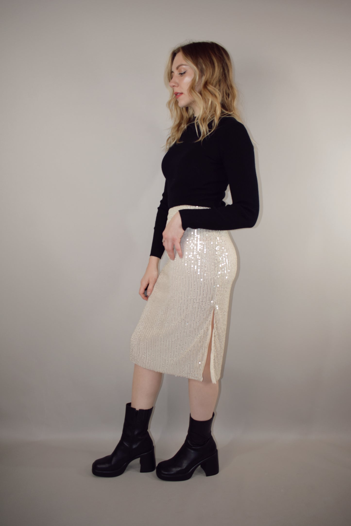 ivory sequin midi pencil skirt with side slit and side zip enclosure hits just below the knee