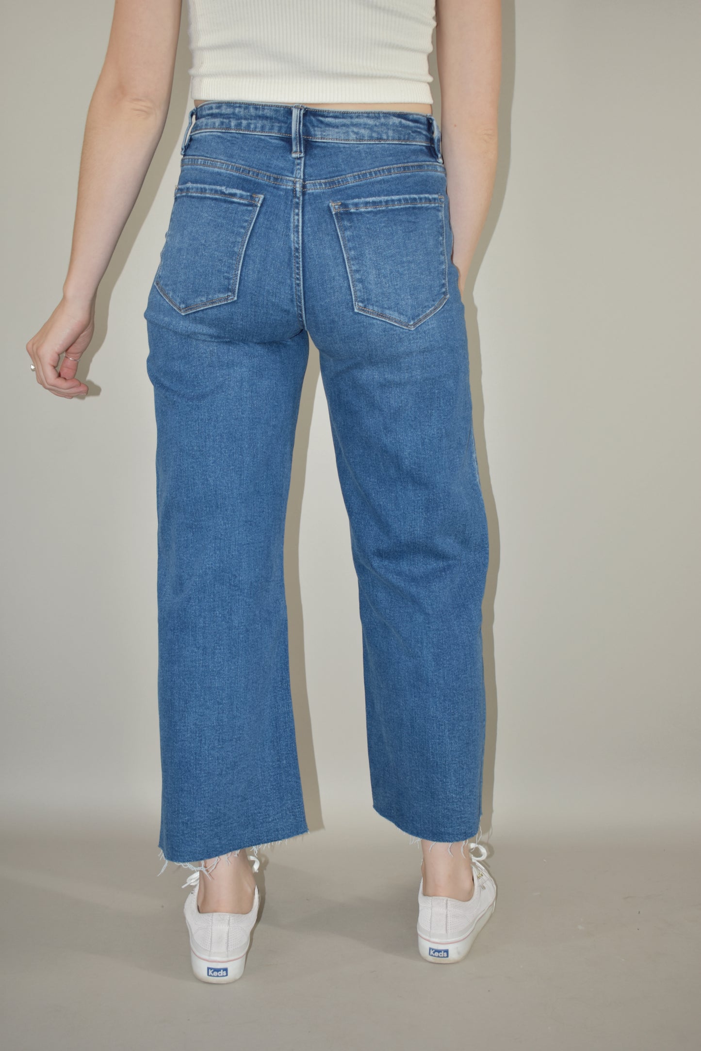 high rise wide leg cropped medium wash stretch denim jeans no holes raw hem