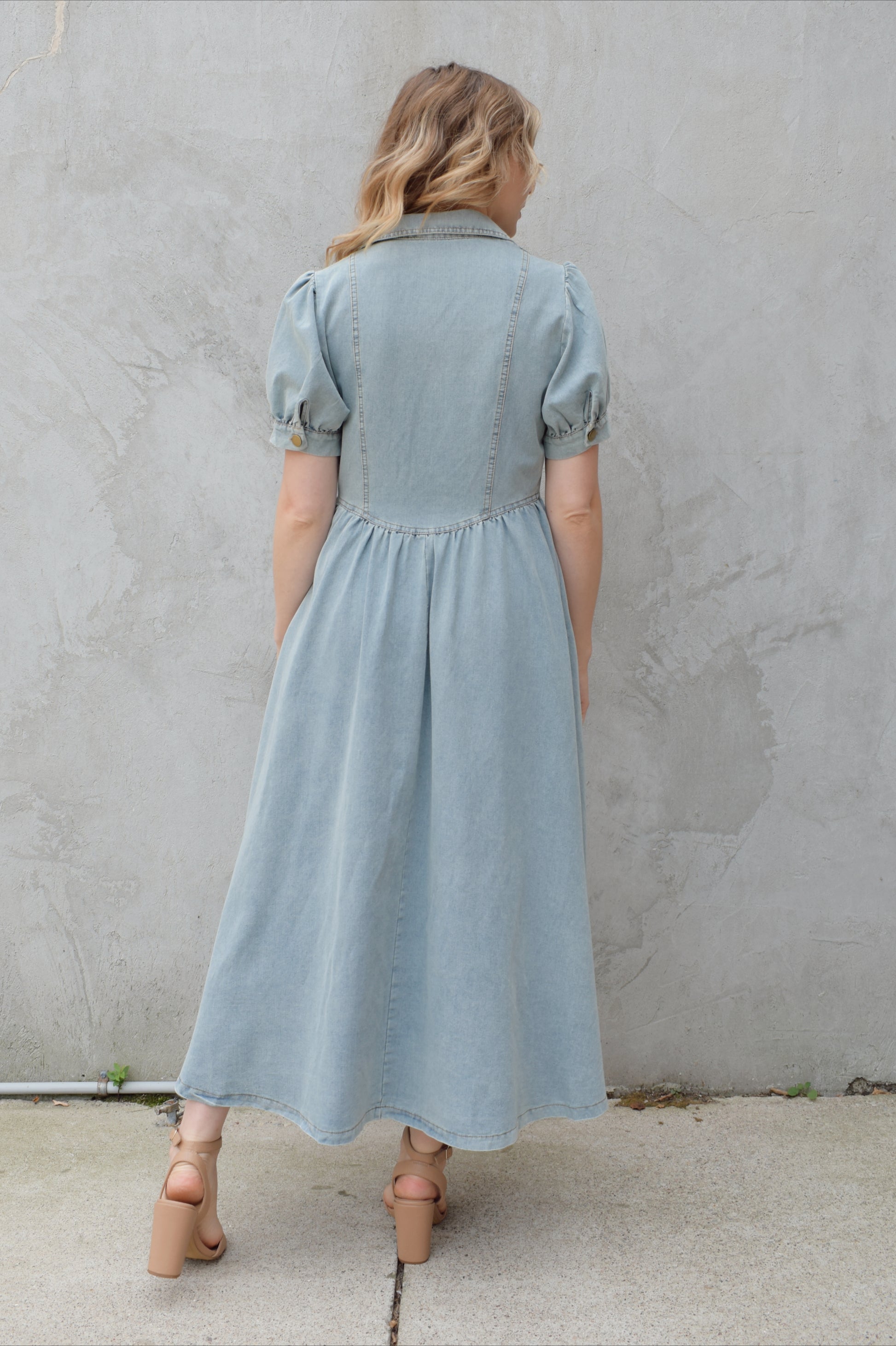 denim midi dress light wash with puff short sleeves with button cuffs button down front, v neck and collar, gathered at waist with a line skirt, has pockets