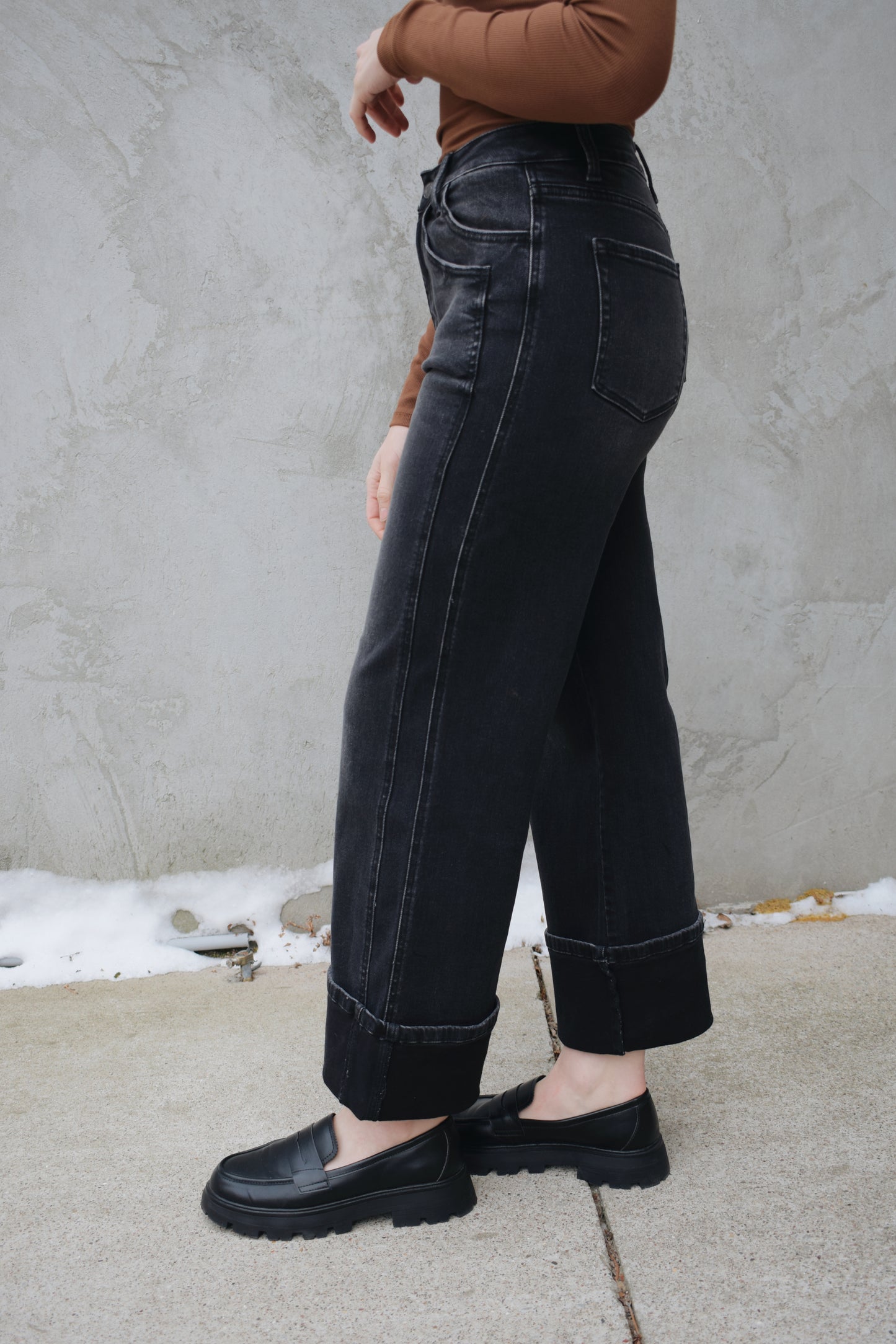 high rise stretch denim black wash no holes wide leg double panel with double front pocket has beltloops zip and button enclosure wide cuff at hem that can be uncuffed