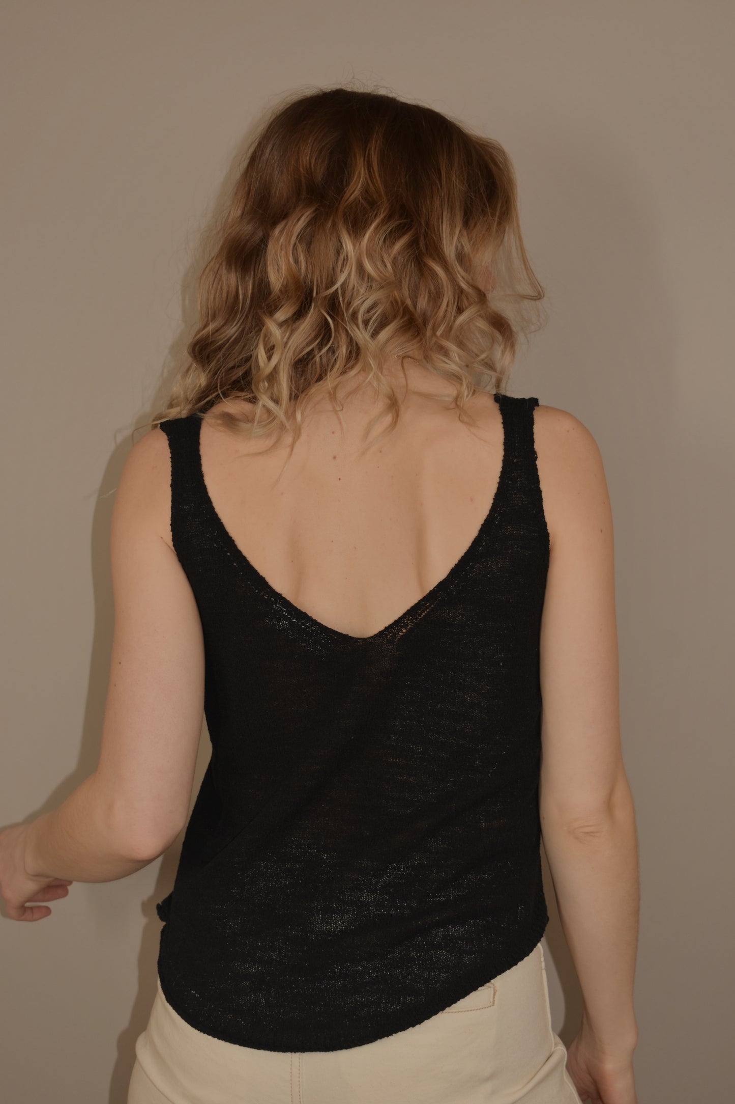 thin and lightweight sweater tank with v neck and rounded hem. full length. relaxed fit.