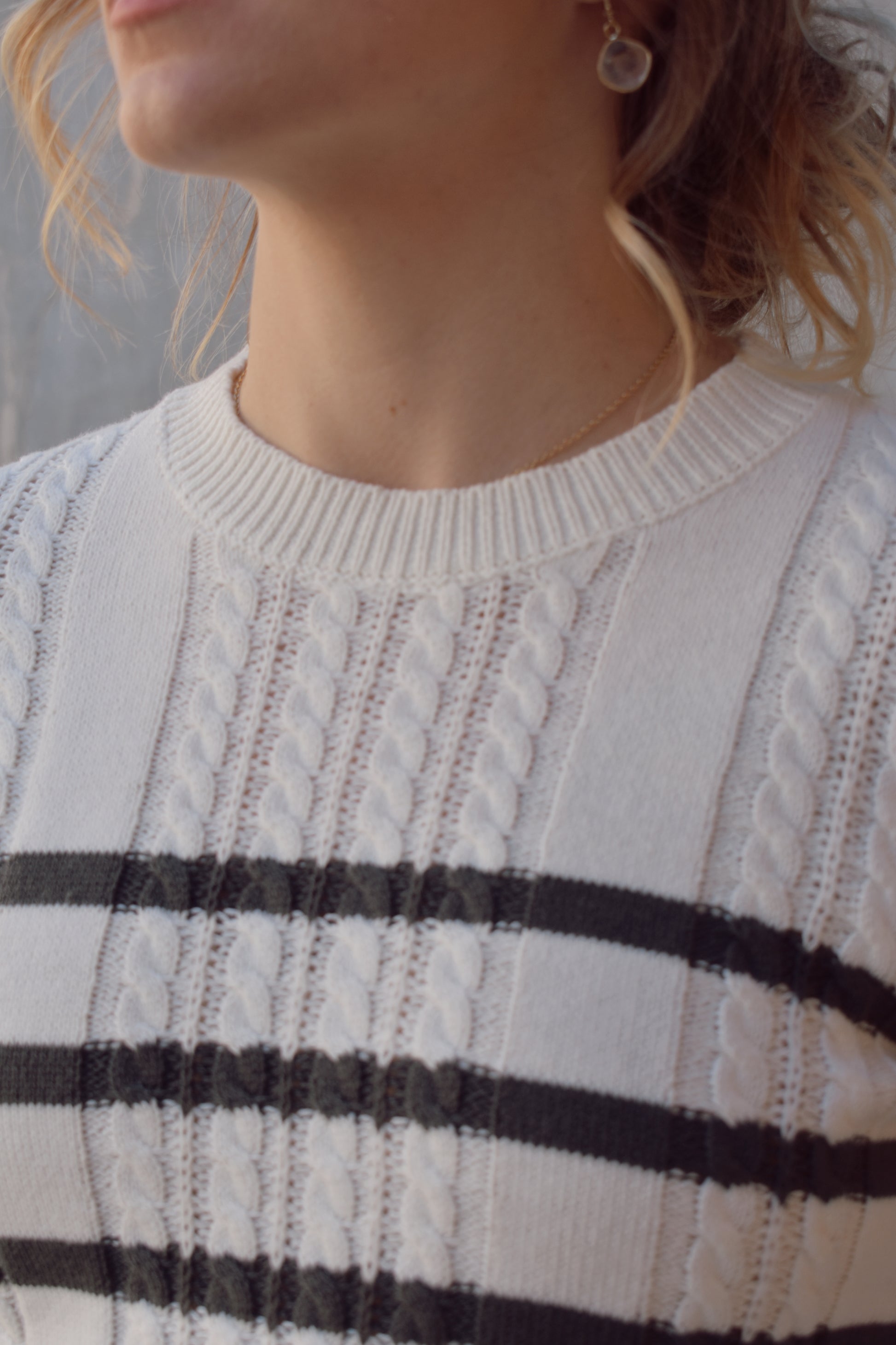 ivory crew neck long sleeve lightweight cable sweater with grey horizontal stripes across bodice and sleeves. cable texture is vertical. full length, ribbed cuffs, hem and neckline. 