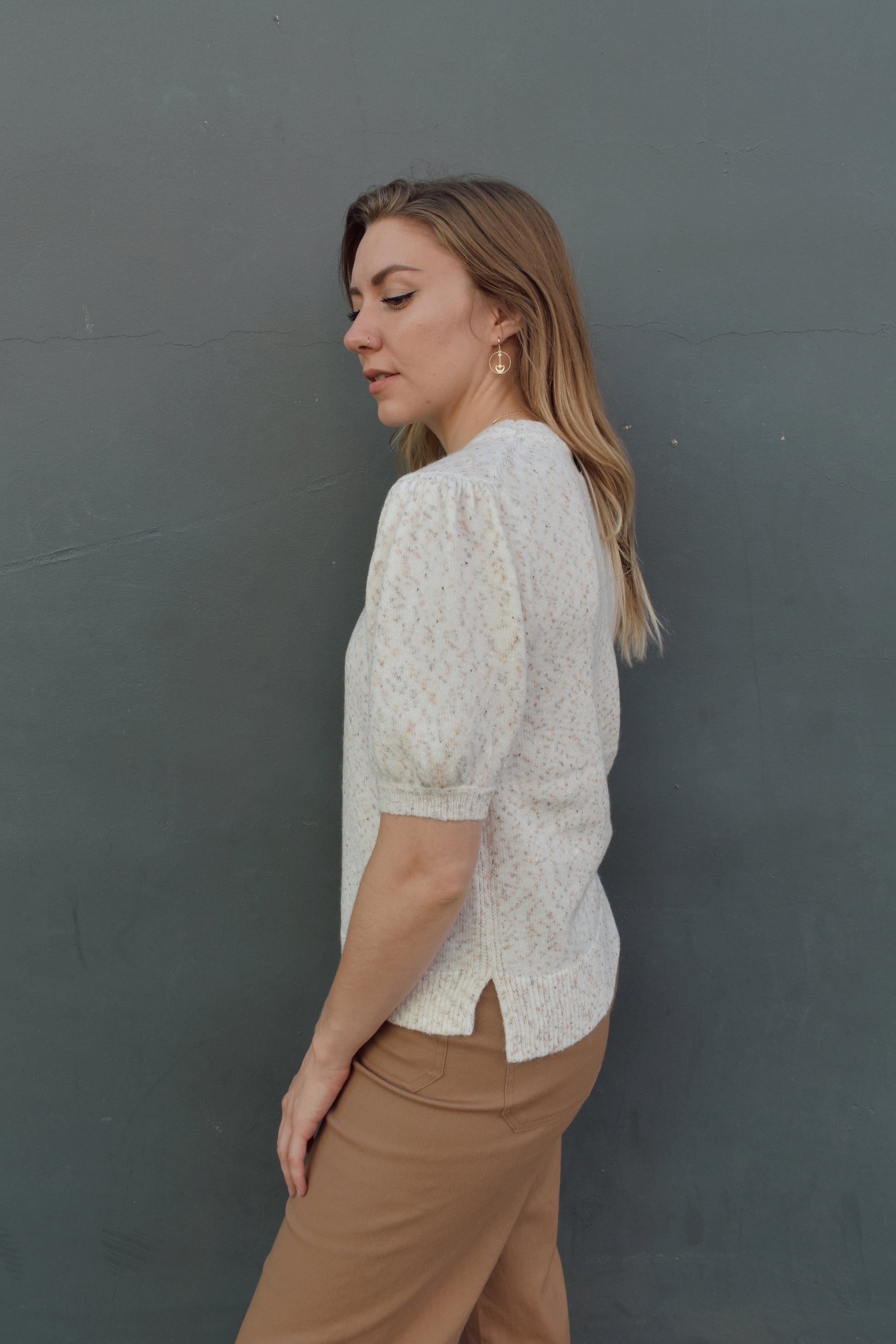 full length sweater with short balloon sleeves and crew neck,  fleck detailed with other colors of yarn, neutral colors. slits on side of hem