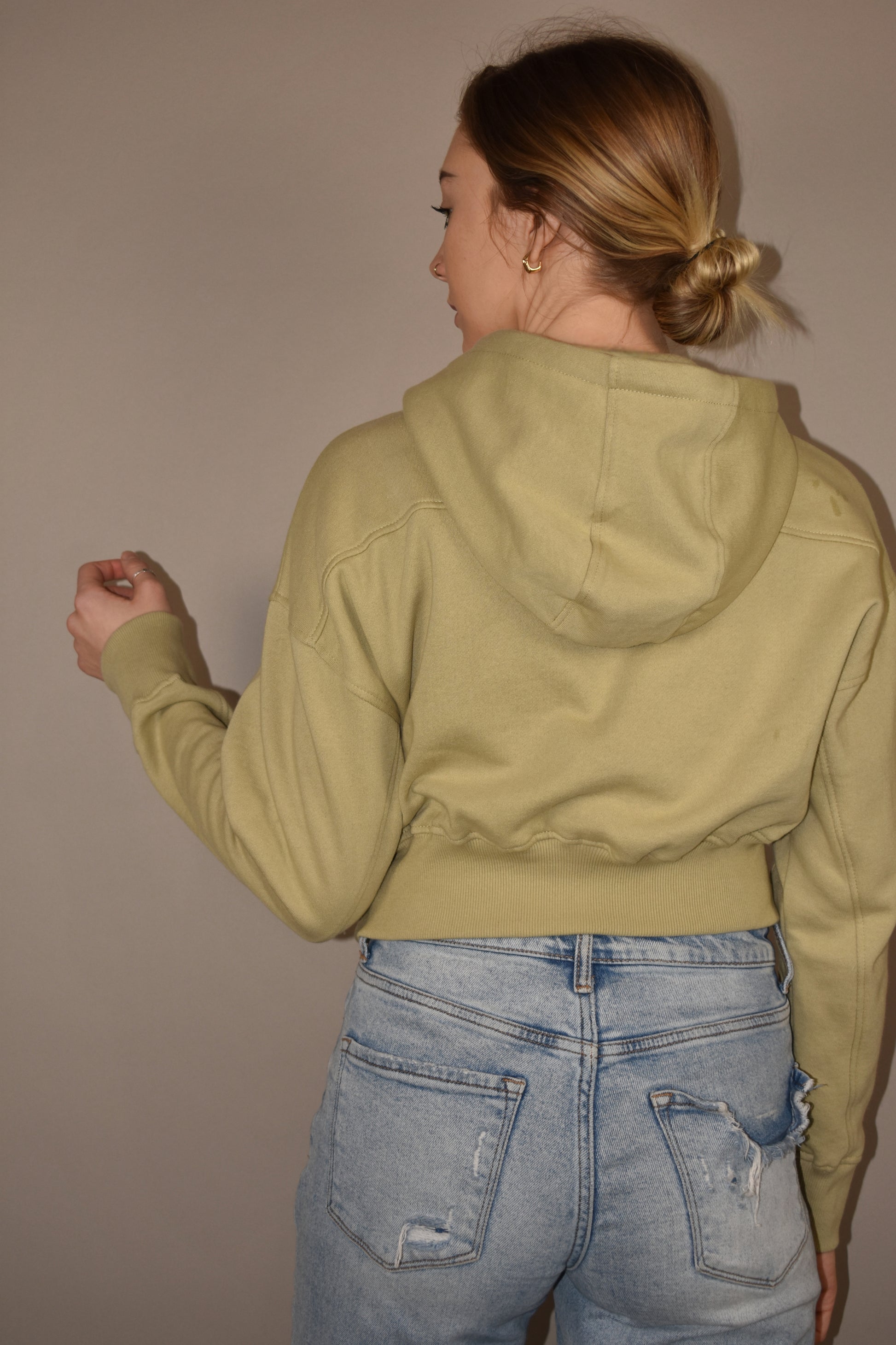 Cropped hoodie with half placket zip with button closure at neckline. Ribbed cuffs and fleece lining.