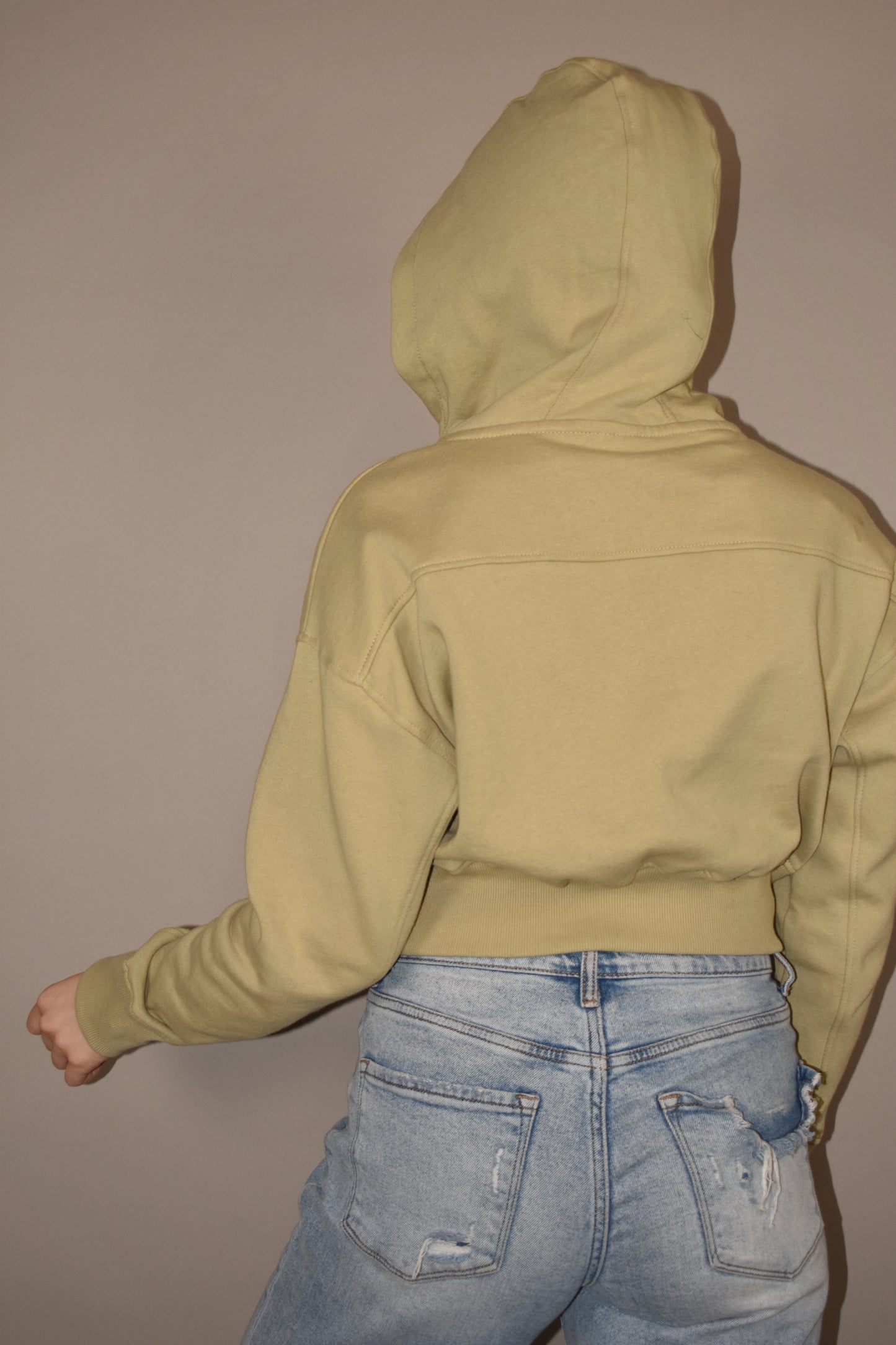 Cropped hoodie with half placket zip with button closure at neckline. Ribbed cuffs and fleece lining.