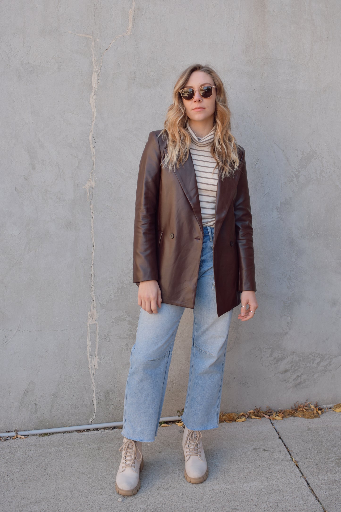 brown faux leather blazer with front flap pockets and front lapel hits at upper thigh split in back hem - fitted