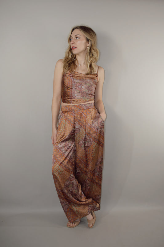 paisley printed satin high waisted full length wide leg pants with fitted band at waist and elastic stretch on back of band has pockets and pleats on front