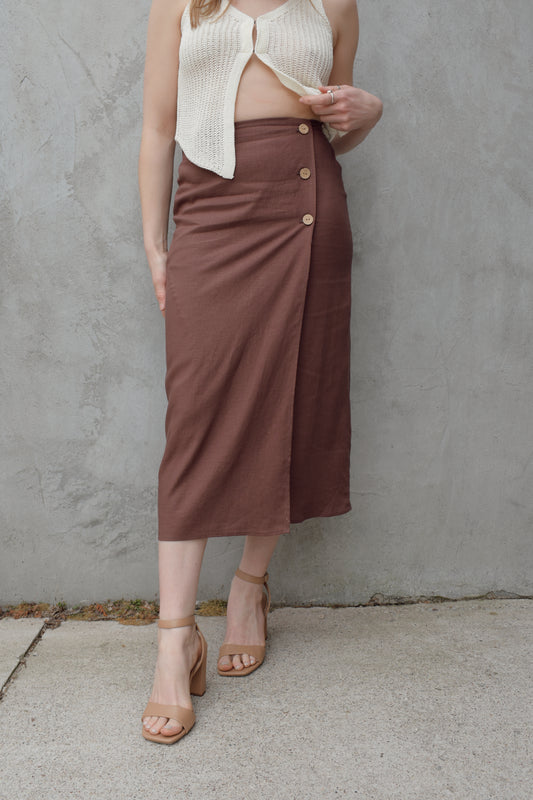 high waisted linen wrap skirt with 3 wooden button enclosure midi length stretch on back of waistband