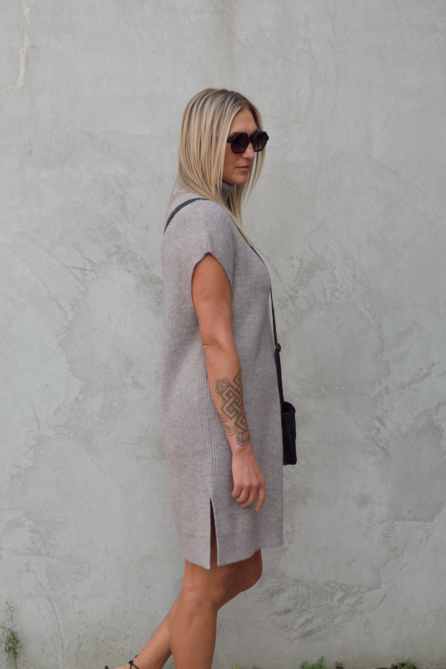 turtleneck sleeveless mini sweater dress hits rig above the knee has slits on side of hem relaxed cap sleeve, straight fit