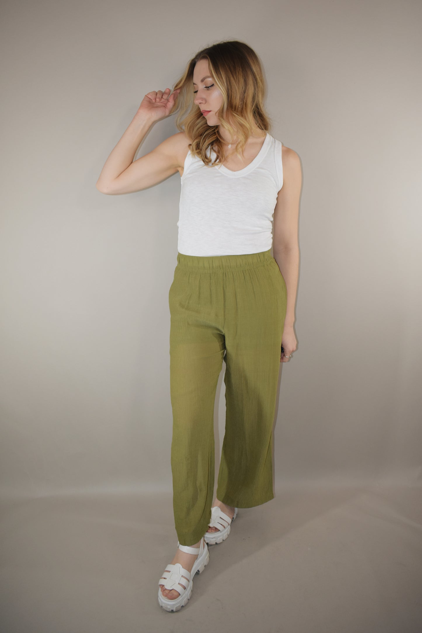 breezy lightweight olive pants slight wide leg high waisted with elastic waistband and shorts length liner has pockets in front not in back