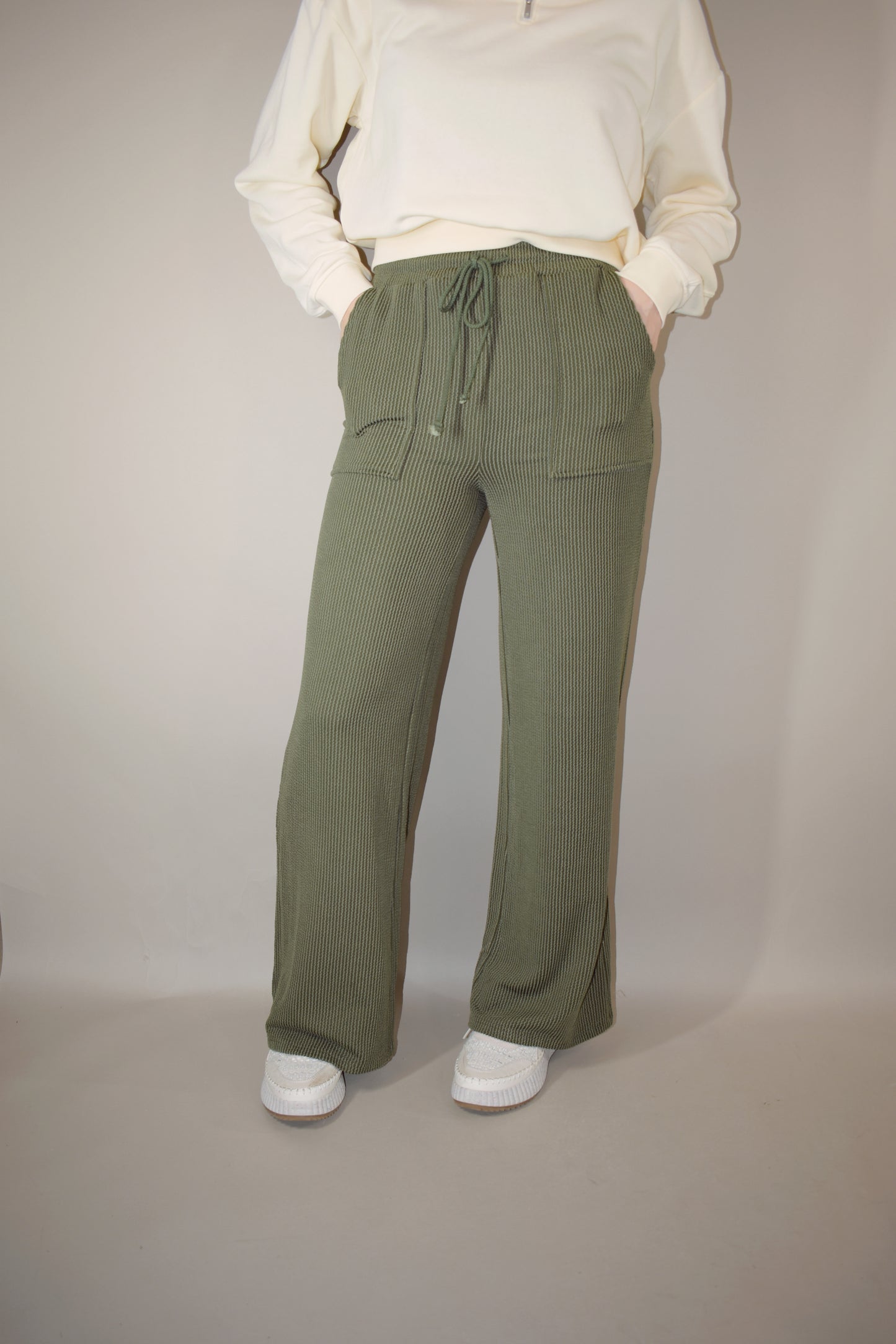 full length high waisted wide leg ribbed olive green athleisure pants with elastic waistband, drawstring, and front pockets.