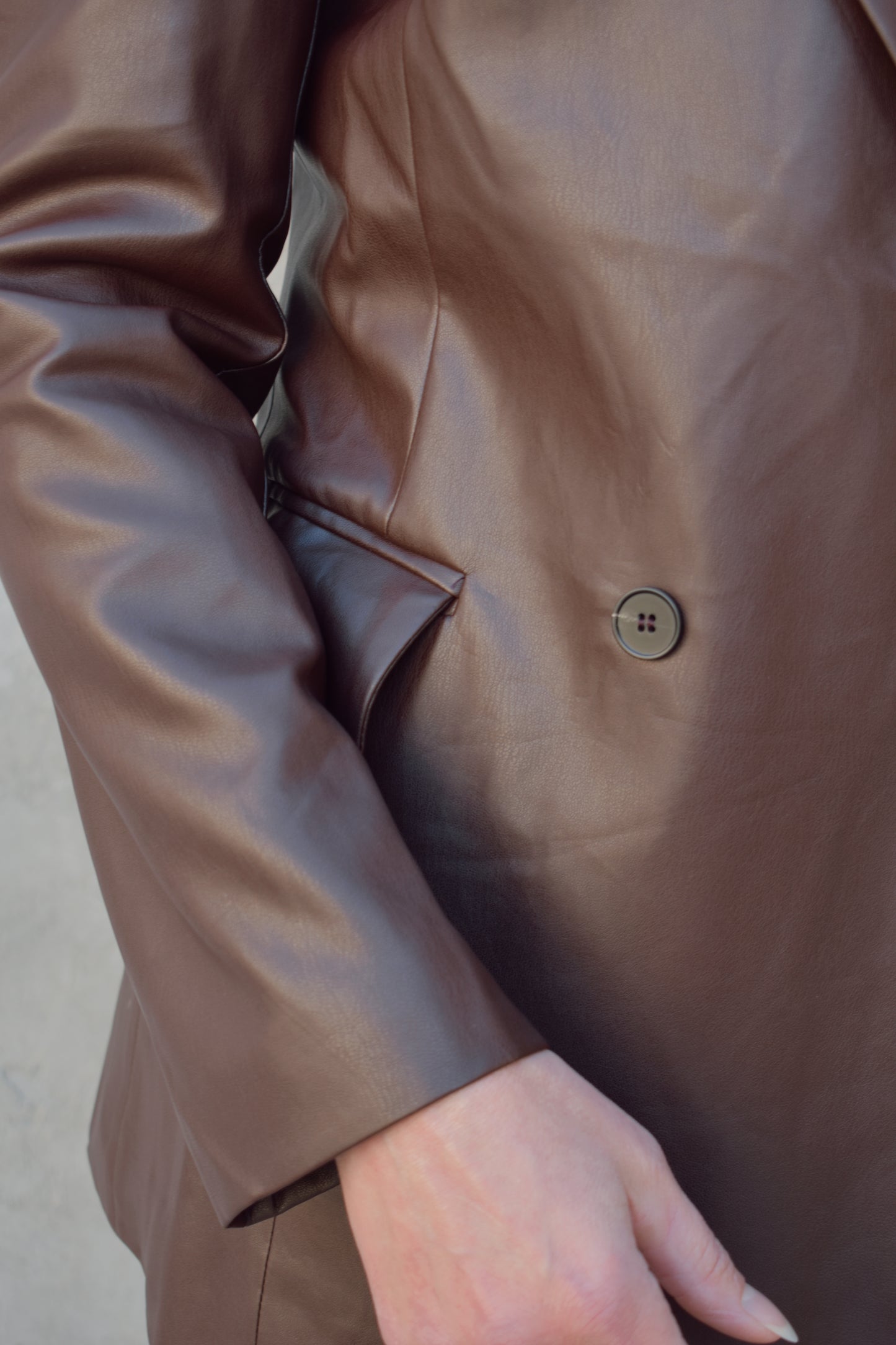 brown faux leather blazer with front flap pockets and front lapel hits at upper thigh split in back hem - fitted