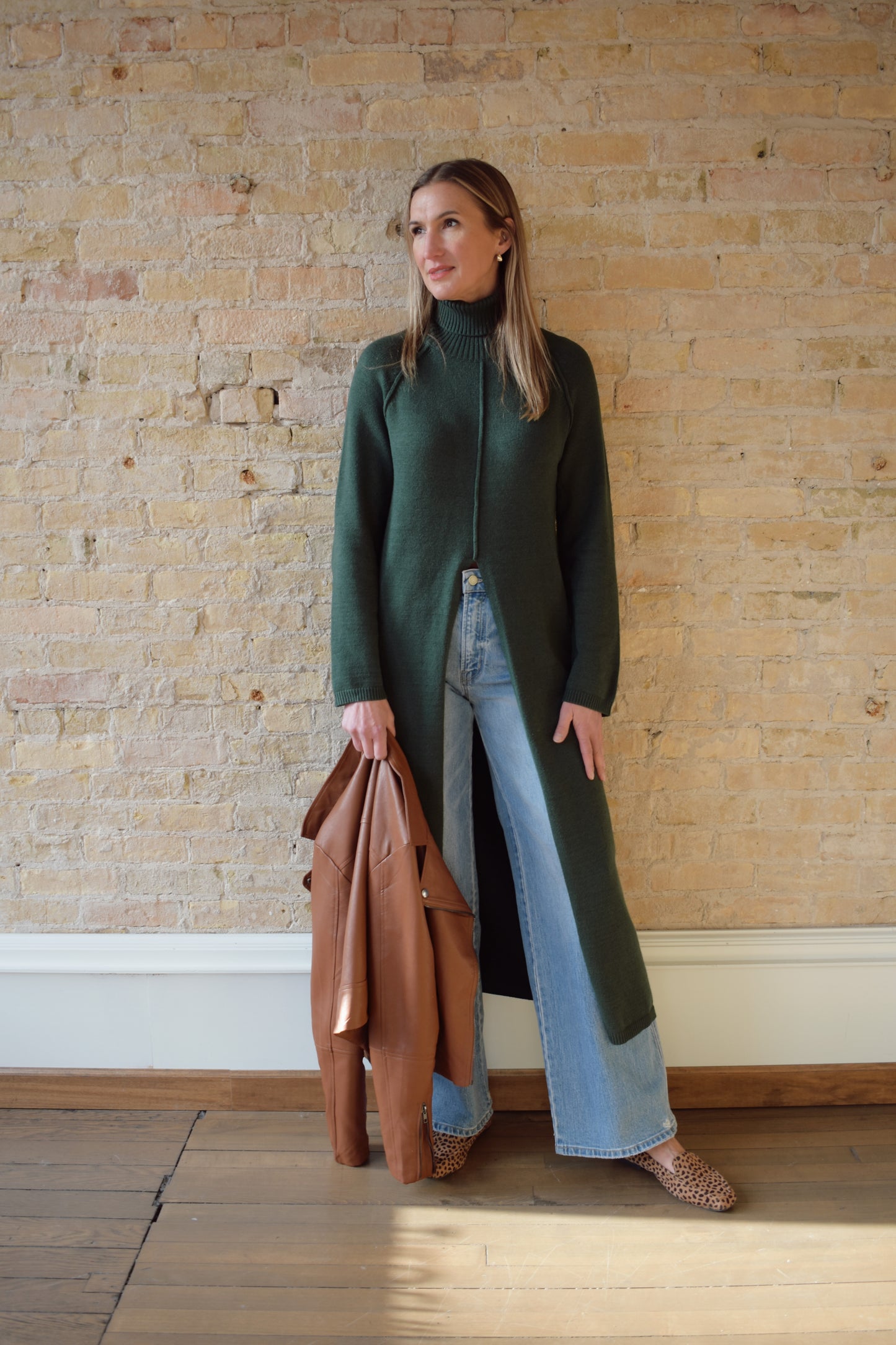 turtleneck tunic sweater dress with split in front up to above waistline, exposed seam detailing down the front and back