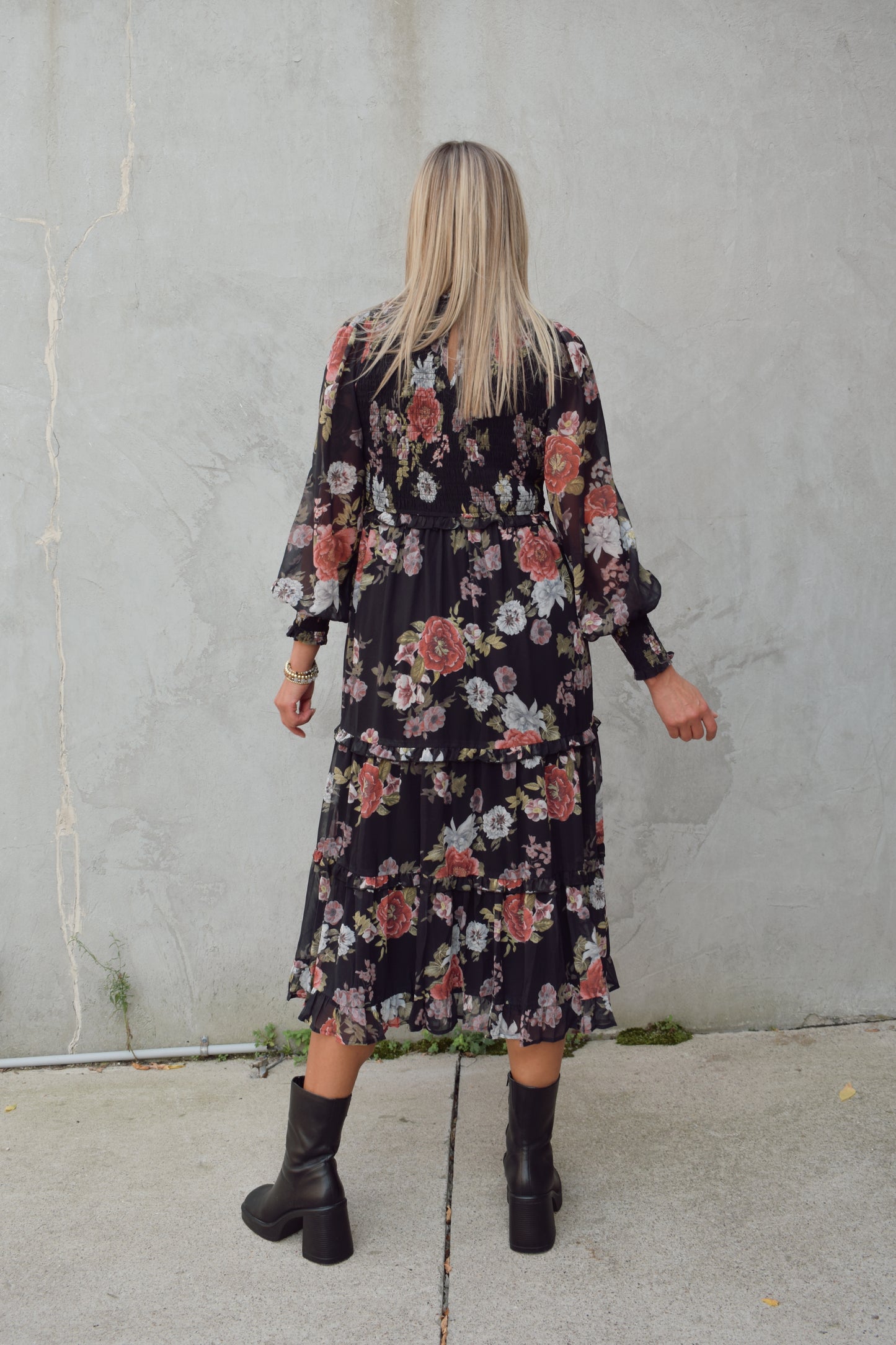 dressy floral midi dress with black background, chiffon material with sheer long sleeves, smocking on bodice and cuffs, high neck, tiered skirt.