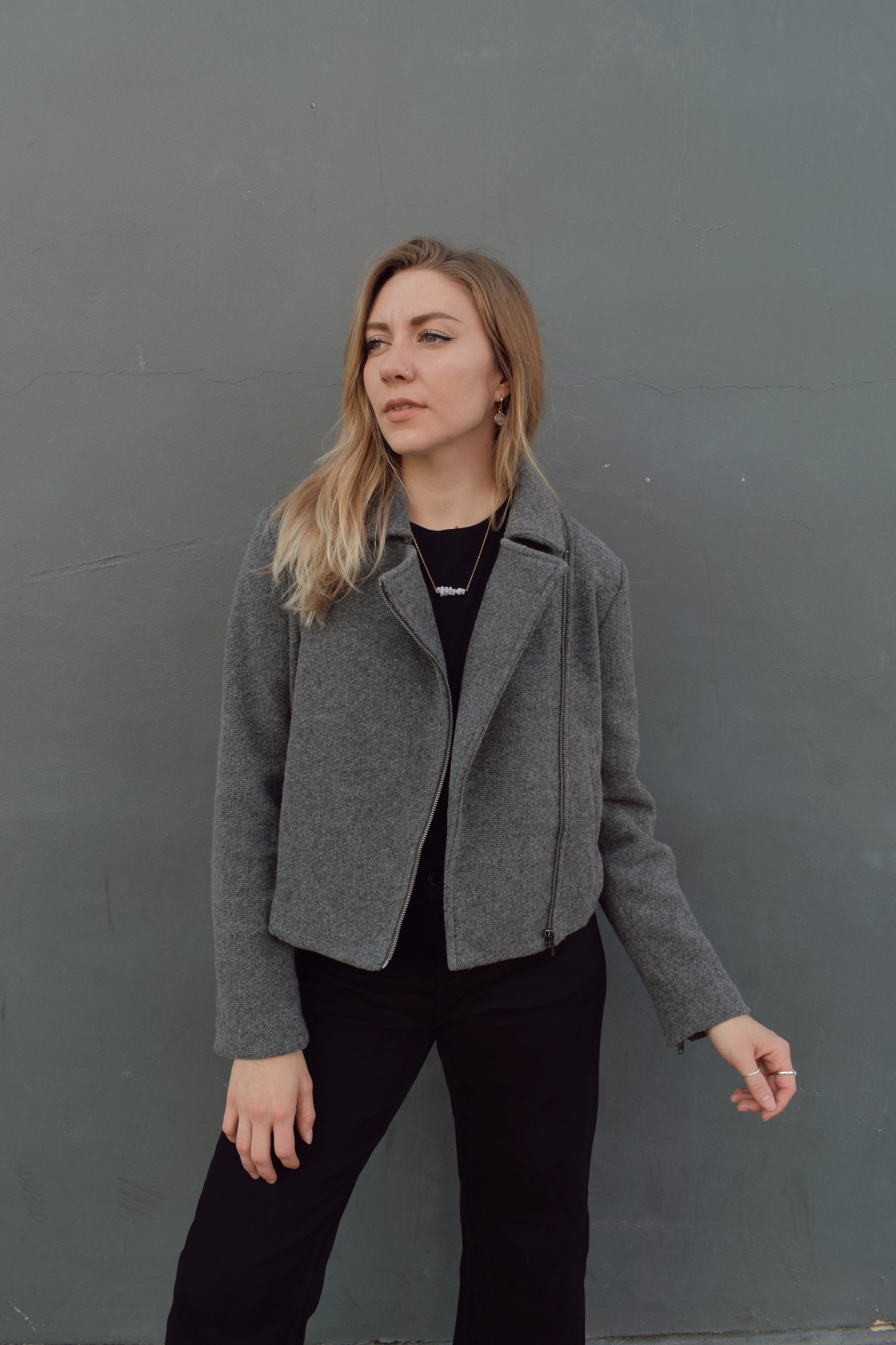 slightly cropped grey moto jacket with notched collar and zip enclosure and has pockets